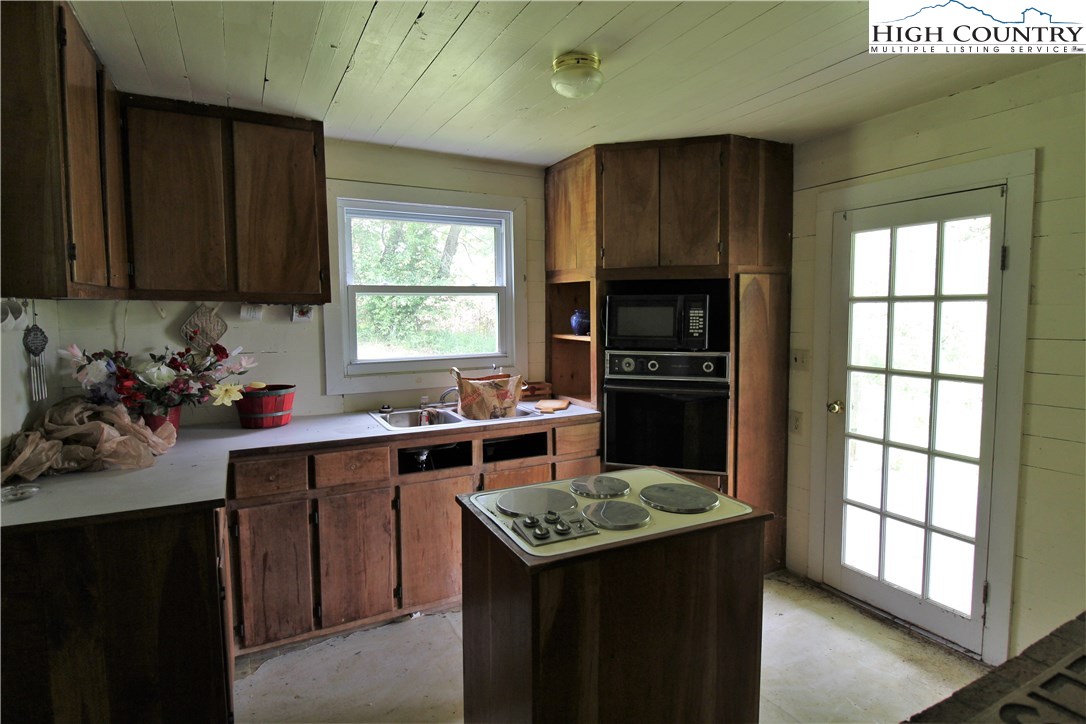 1419 Joe Hampton Road Lansing, NC 28643 - Photo 13 of 25 a kitchen with a sink stove and cabinets