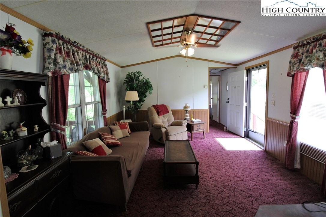 1419 Joe Hampton Road Lansing, NC 28643 - Photo 15 of 25 a living room with furniture fireplace and a flat screen tv