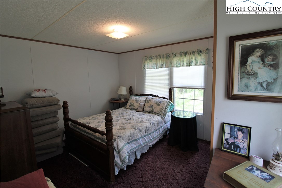 1419 Joe Hampton Road Lansing, NC 28643 - Photo 17 of 25 a bedroom with a bed and a window