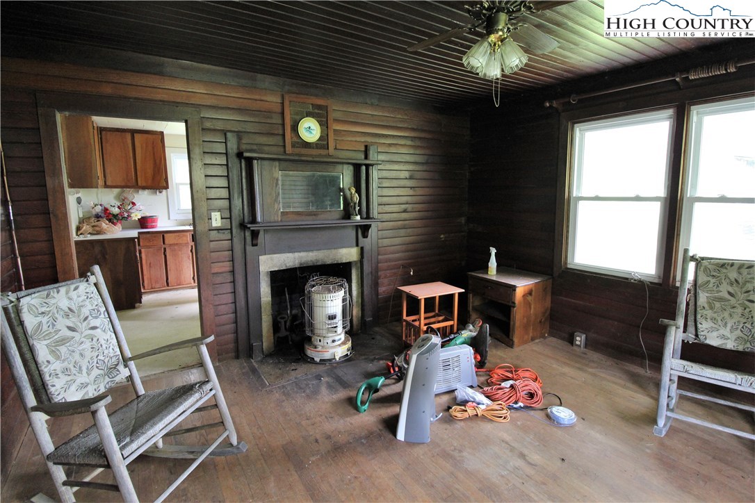 1419 Joe Hampton Road Lansing, NC 28643 - Photo 8 of 25 a living room with furniture a window and a fireplace