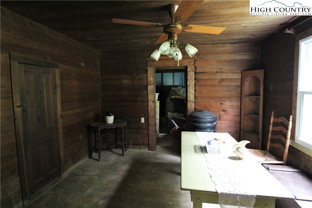 1419 Joe Hampton Road Lansing, NC 28643 - Photo 10 of 25 a dining room with furniture and a chandelier
