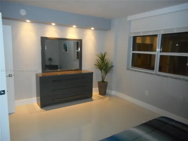 a room with mirror and window