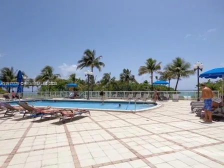 a view of swimming pool with outdoor seating and plants