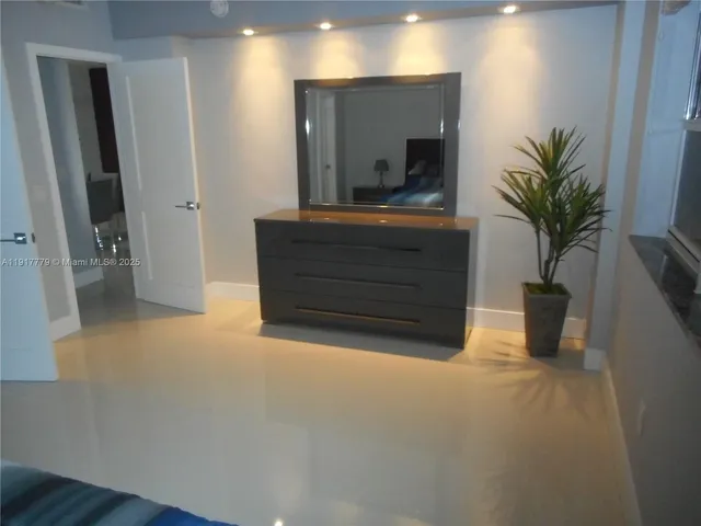 a room with a bench and a potted plant