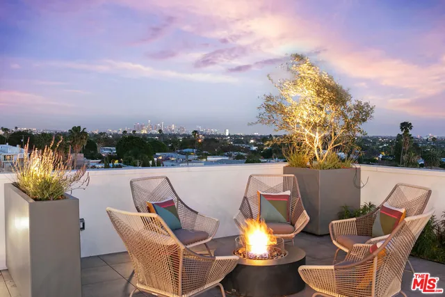 a backyard of a house with table and chairs