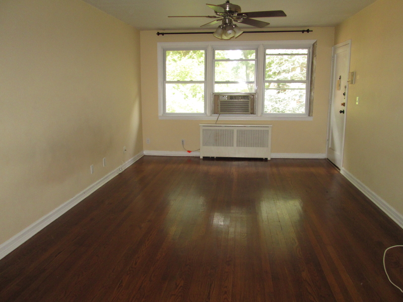 26 High Street, Unit F Fair Lawn, NJ 07410 - Photo 3 of 6 a view of an empty room with wooden floor and a window