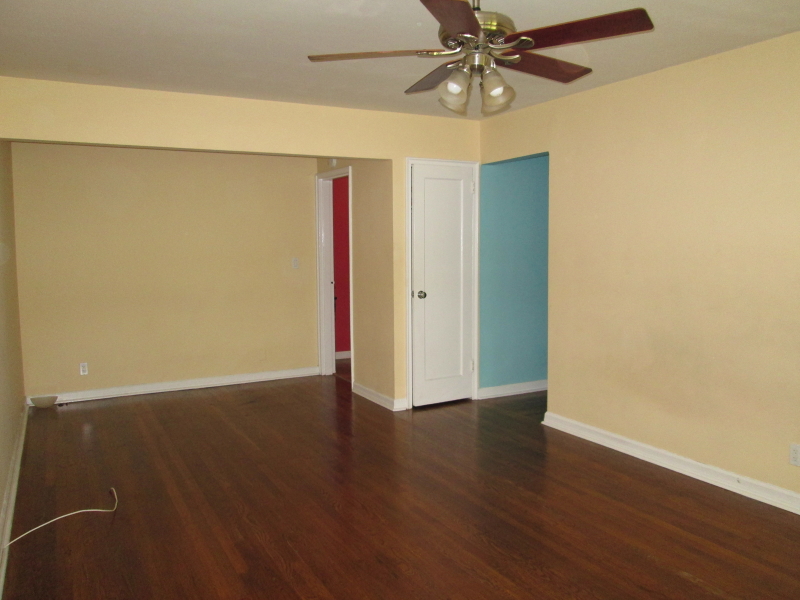 26 High Street, Unit F Fair Lawn, NJ 07410 - Photo 4 of 6 an empty room with wooden floor and fan