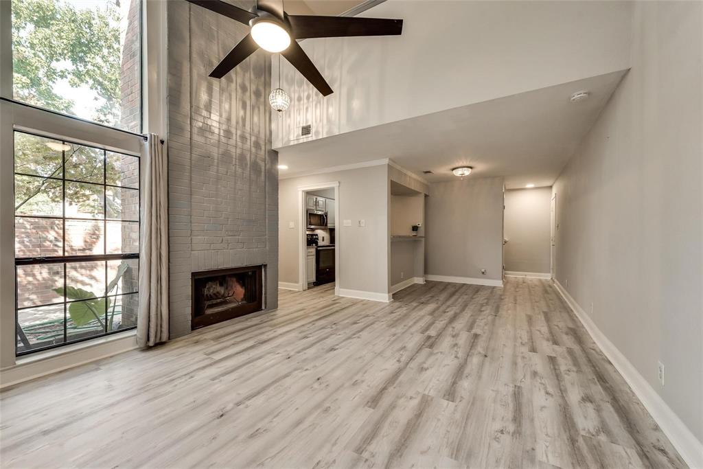 18240 Midway Road, Unit 302 Dallas, TX 75287 - Photo 4 of 33 a view of empty room with wooden floor and fan