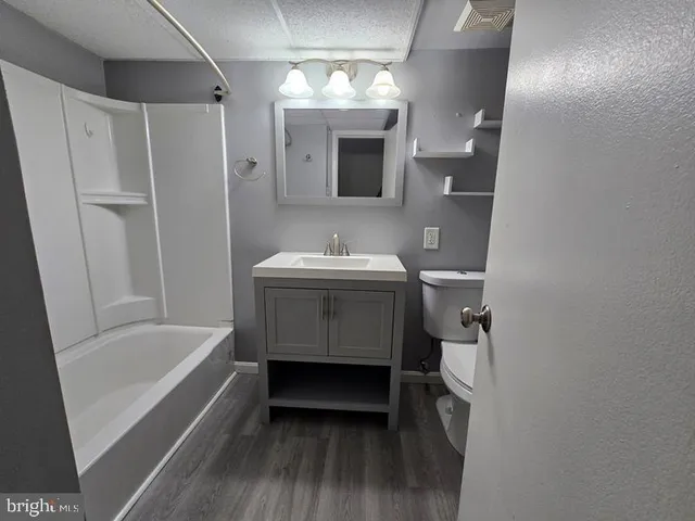 a bathroom with a sink tub and a mirror