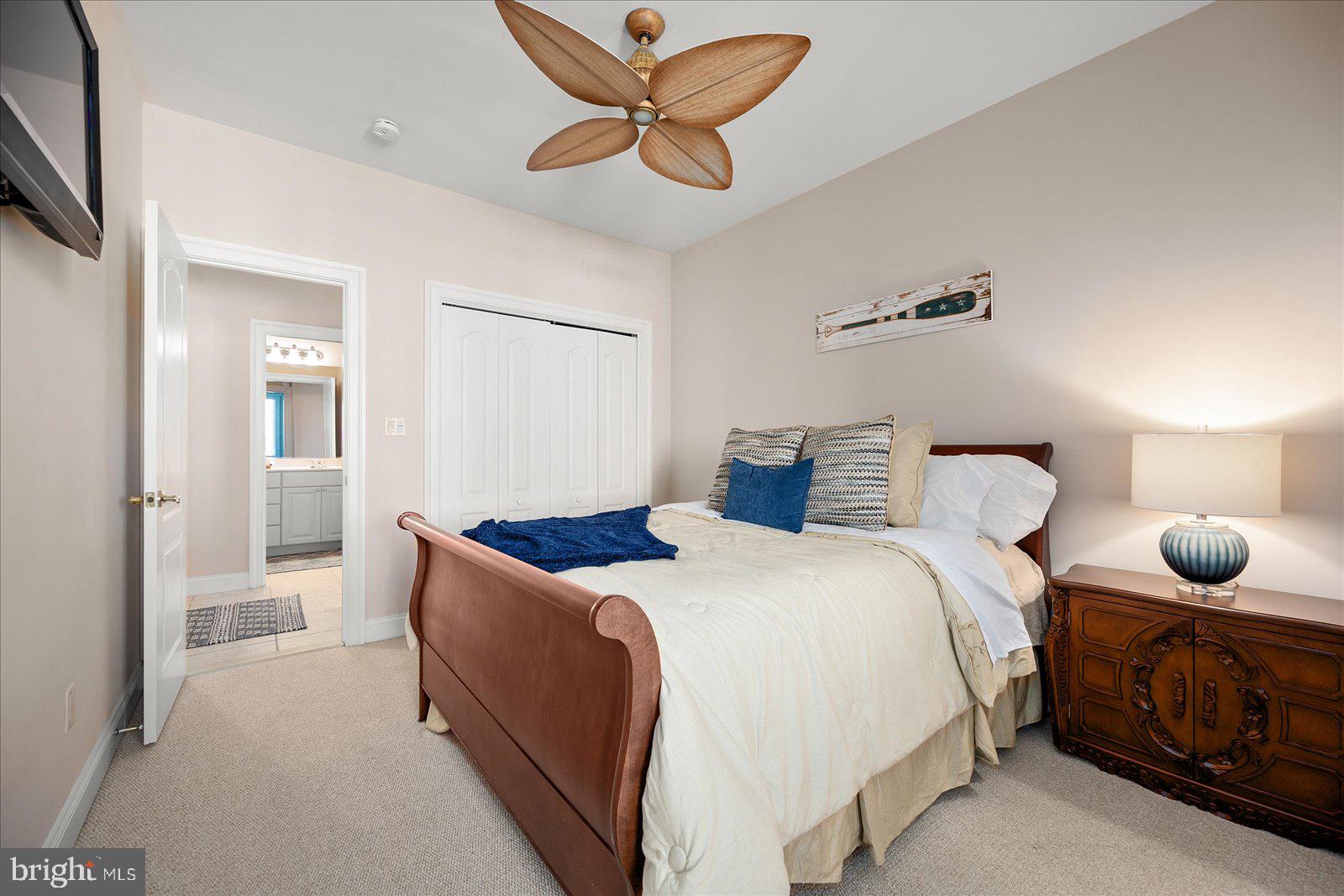 12901 Old Bridge Road, Unit PH8 2 Ocean City, MD 21842 - Photo 37 of 79 a bedroom with a bed and ceiling fan