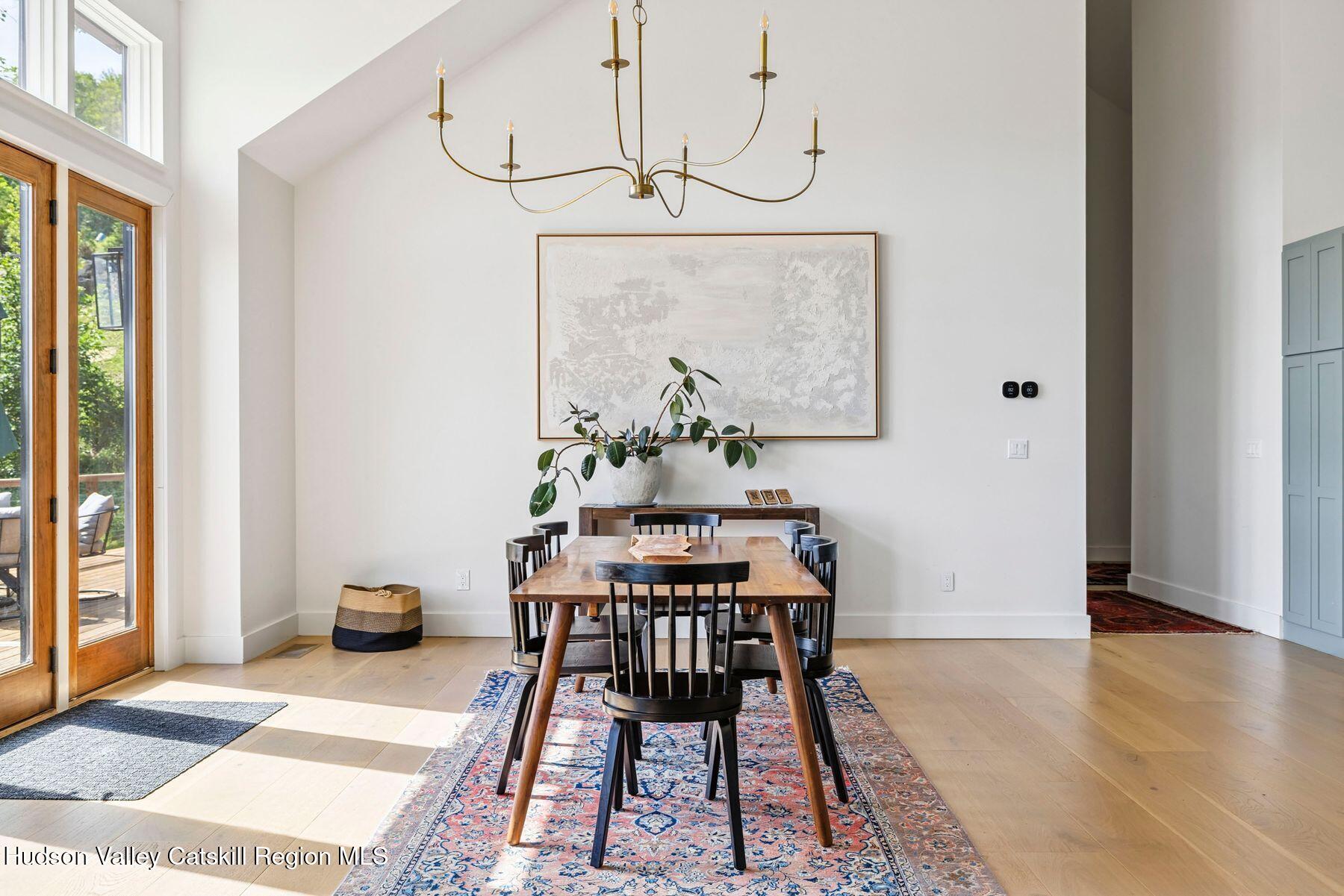 219 Club Road Windham, NY 12496 - Photo 13 of 103 a view of a dining room with furniture wooden floor and a chandelier