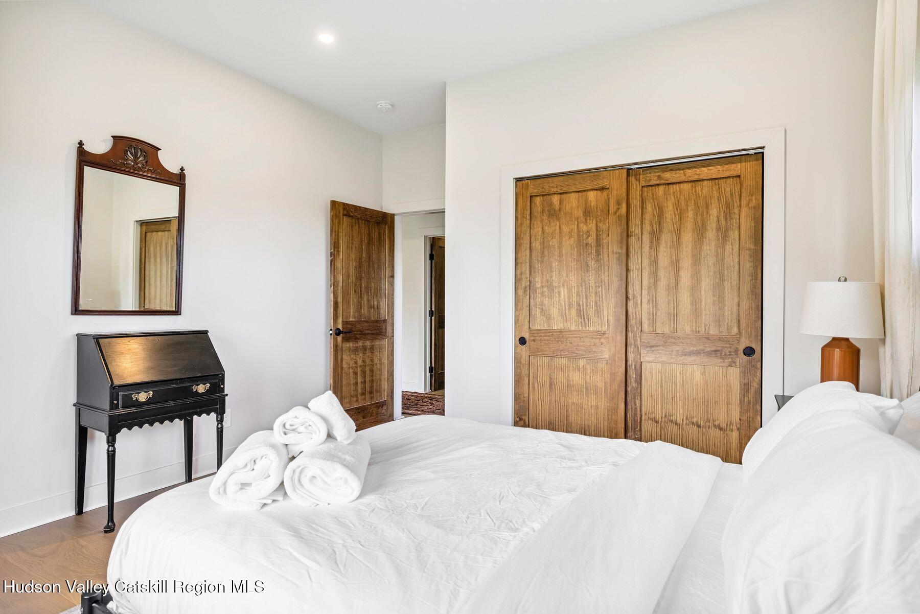 219 Club Road Windham, NY 12496 - Photo 30 of 103 a bedroom with a bed and a flat screen tv