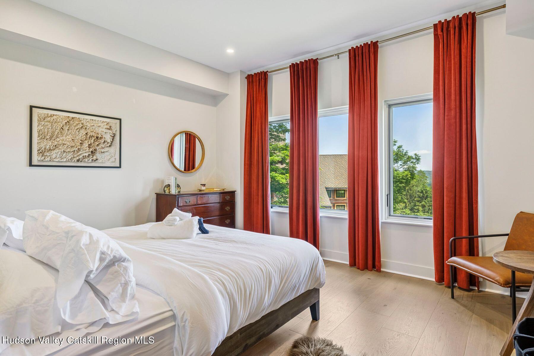 219 Club Road Windham, NY 12496 - Photo 31 of 103 a bedroom with a large bed and a large window