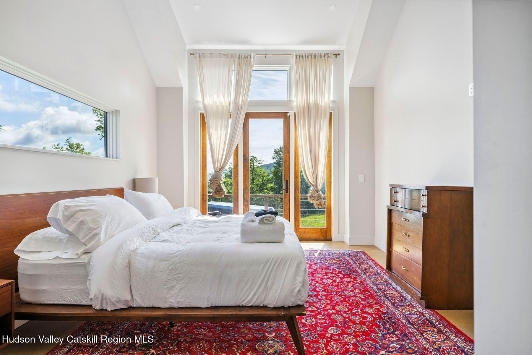 219 Club Road Windham, NY 12496 - Photo 34 of 103 a bedroom with a bed and a painting on the wall