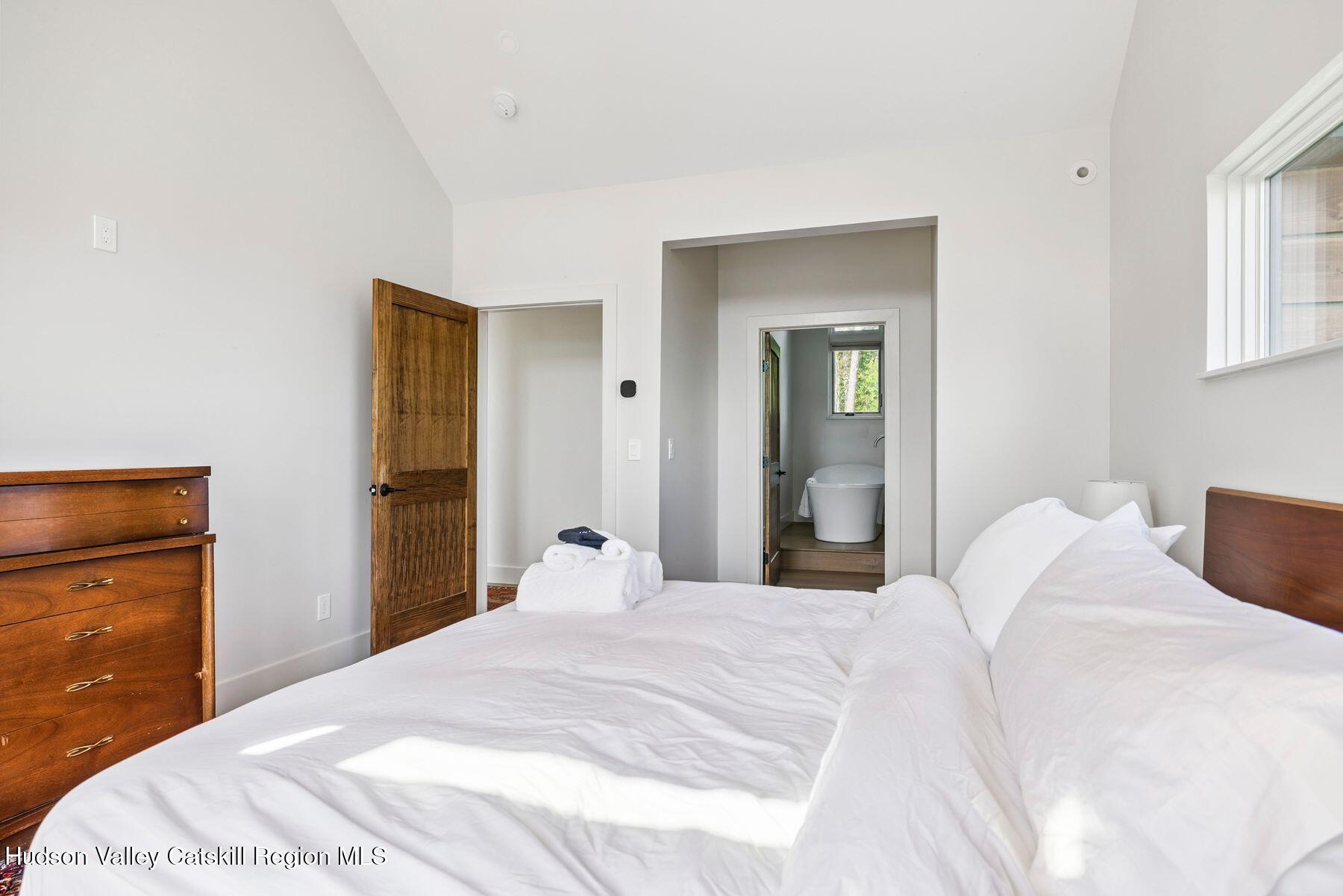 219 Club Road Windham, NY 12496 - Photo 37 of 103 a bedroom with a bed and a mirror