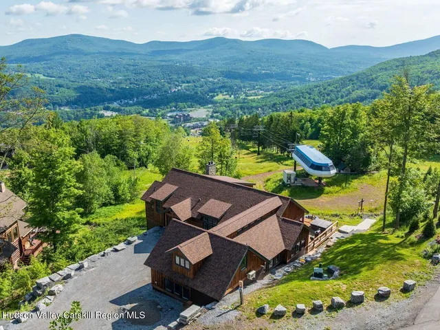 a living room with fireplace furniture and a large window