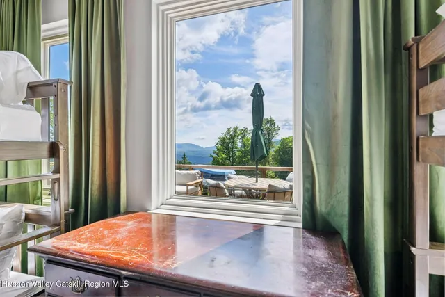 a kitchen with stainless steel appliances granite countertop a sink a stove and chairs