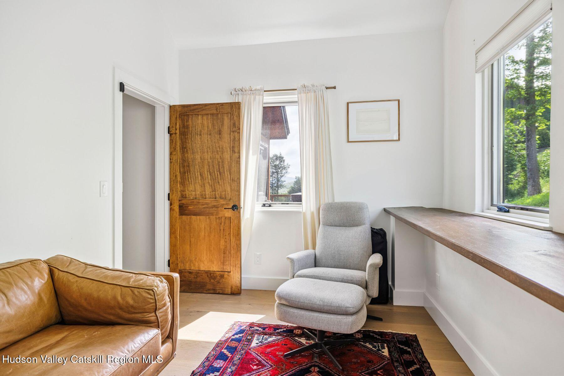 219 Club Road Windham, NY 12496 - Photo 43 of 103 a living room with furniture and a window