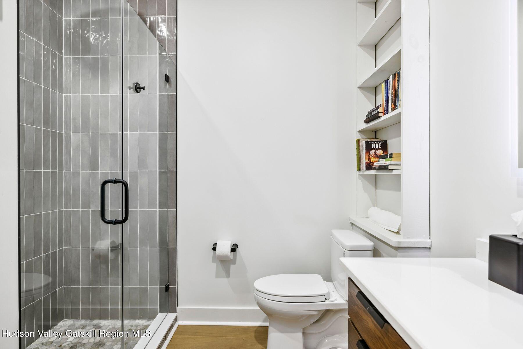 219 Club Road Windham, NY 12496 - Photo 54 of 103 a bathroom with a sink toilet and shower