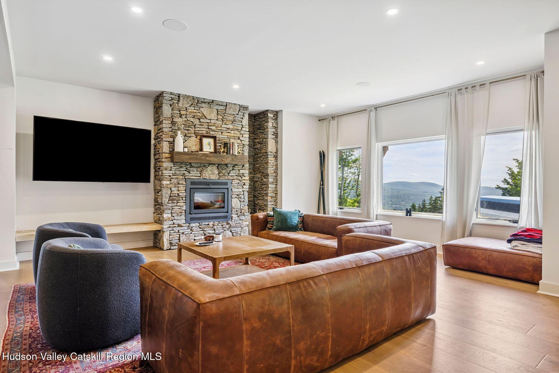 219 Club Road Windham, NY 12496 - Photo 68 of 103 a living room with furniture and a flat screen tv