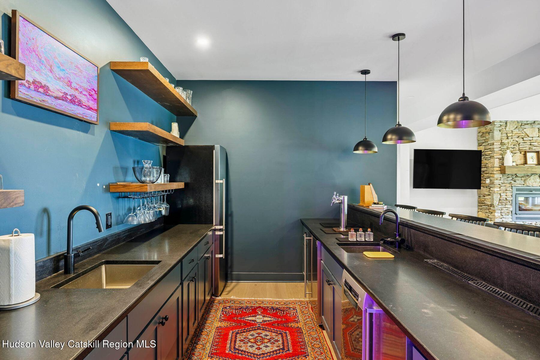 219 Club Road Windham, NY 12496 - Photo 72 of 103 a kitchen with stainless steel appliances granite countertop a sink and a stove