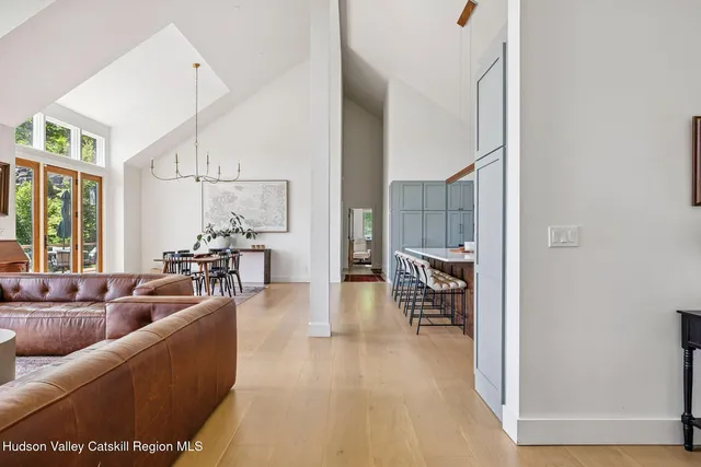 a view of a dining room with furniture wooden floor and a chandelier