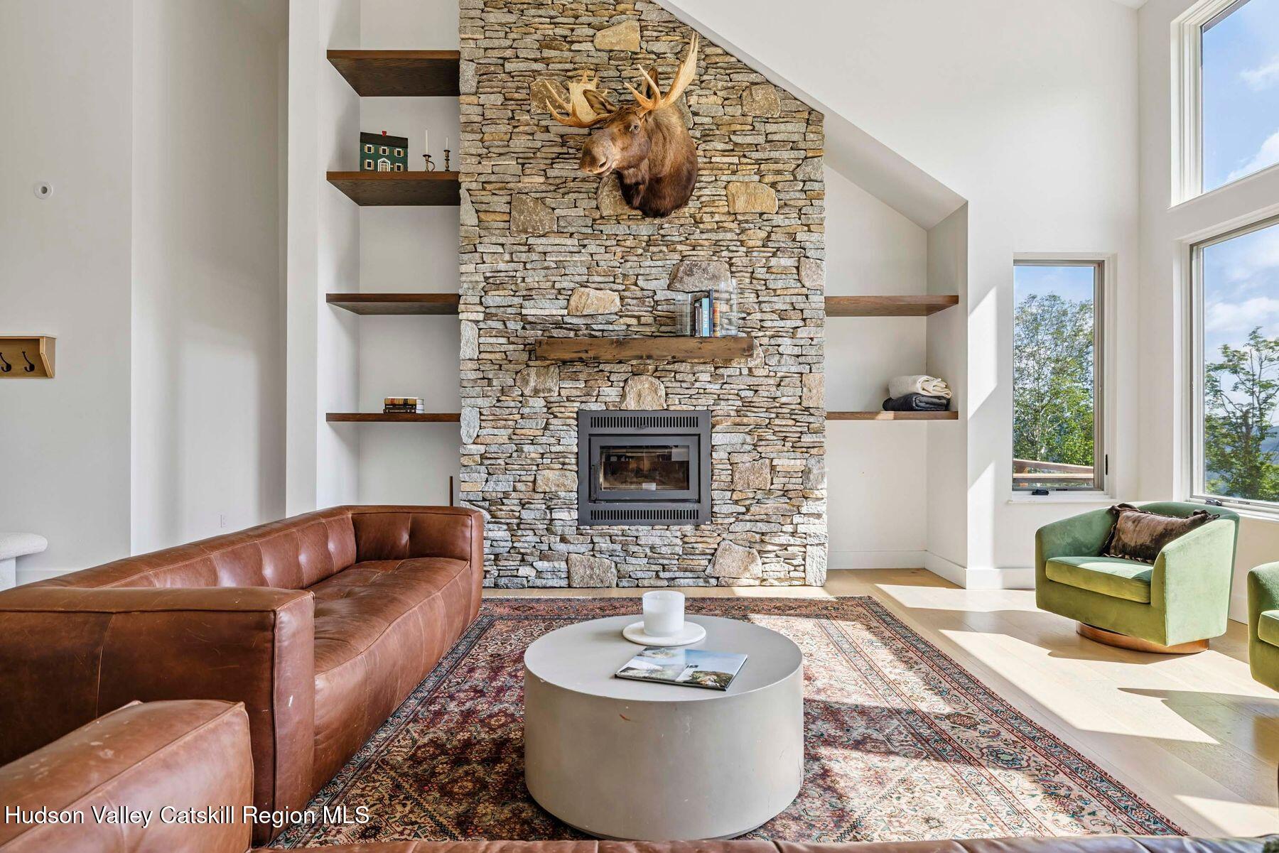 219 Club Road Windham, NY 12496 - Photo 9 of 103 a living room with furniture and a fireplace