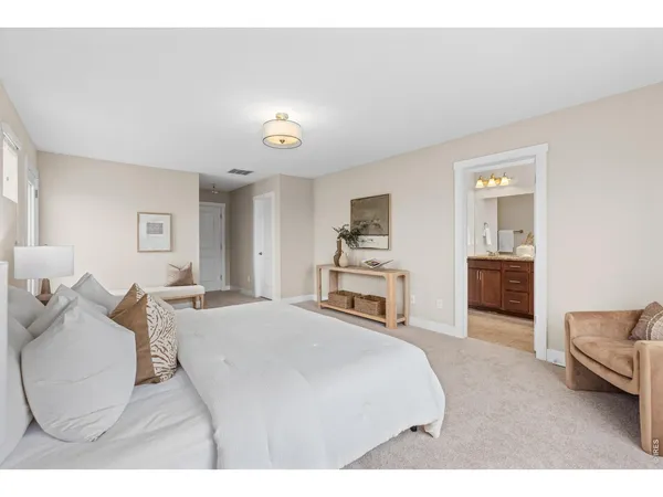 a bedroom with a bed and a couch