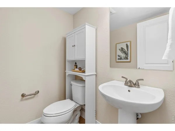 a bathroom with a sink toilet and a mirror