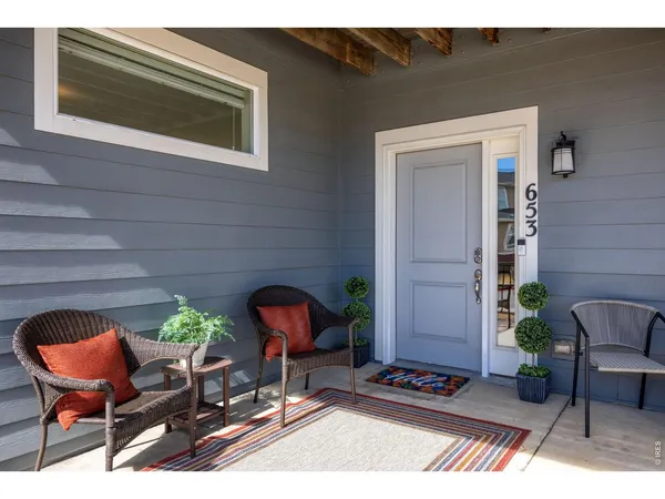 a backyard of a house with outdoor seating