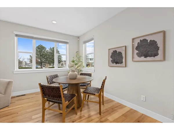 a view of a dining room with furniture window and wooden floor