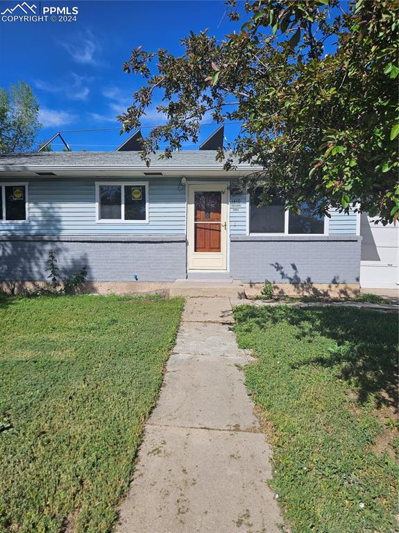 1410 Chadwick Drive Colorado Springs, CO 80906 - Photo 1 of 16 a front view of a house with garden