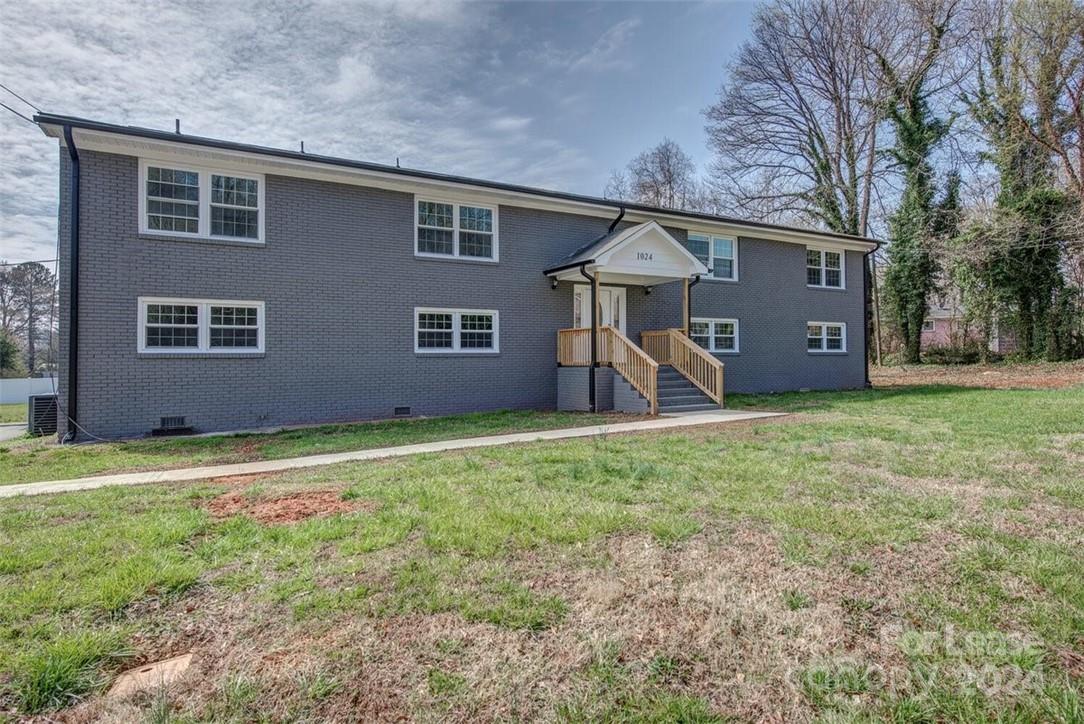 1024 Avondale Road, Unit 4 Lowell, NC 28098 - Photo 2 of 11 a front view of a house with a yard