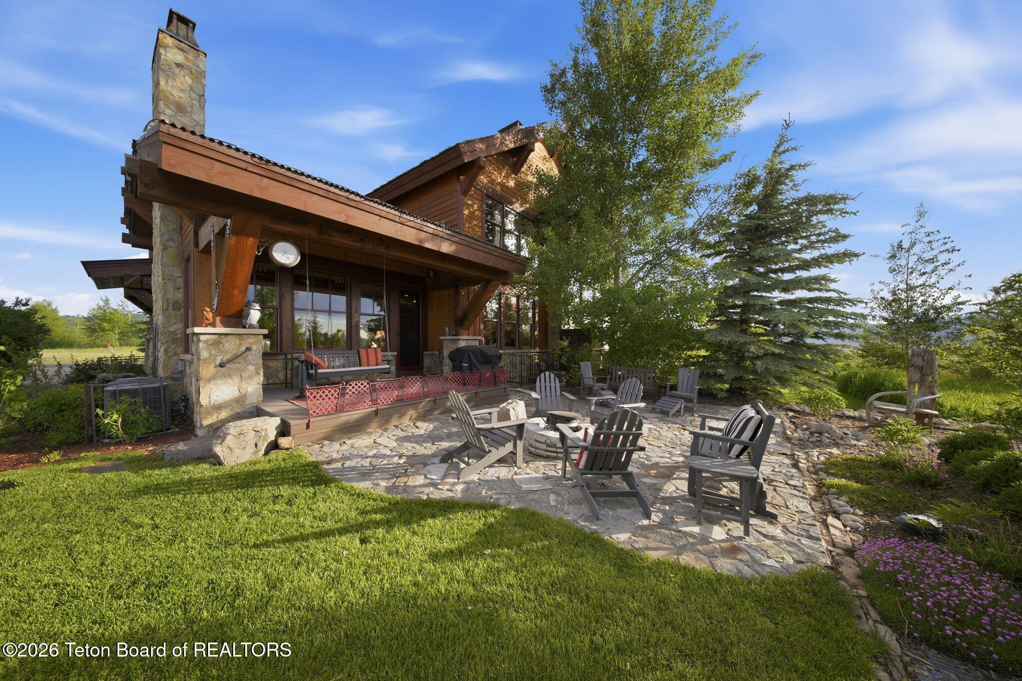 92 Bison Drive Victor, ID 83455 - Photo 3 of 52 3 stone patio and covered porch w swing