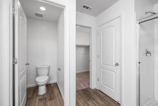 a bathroom with a toilet shower and a sink