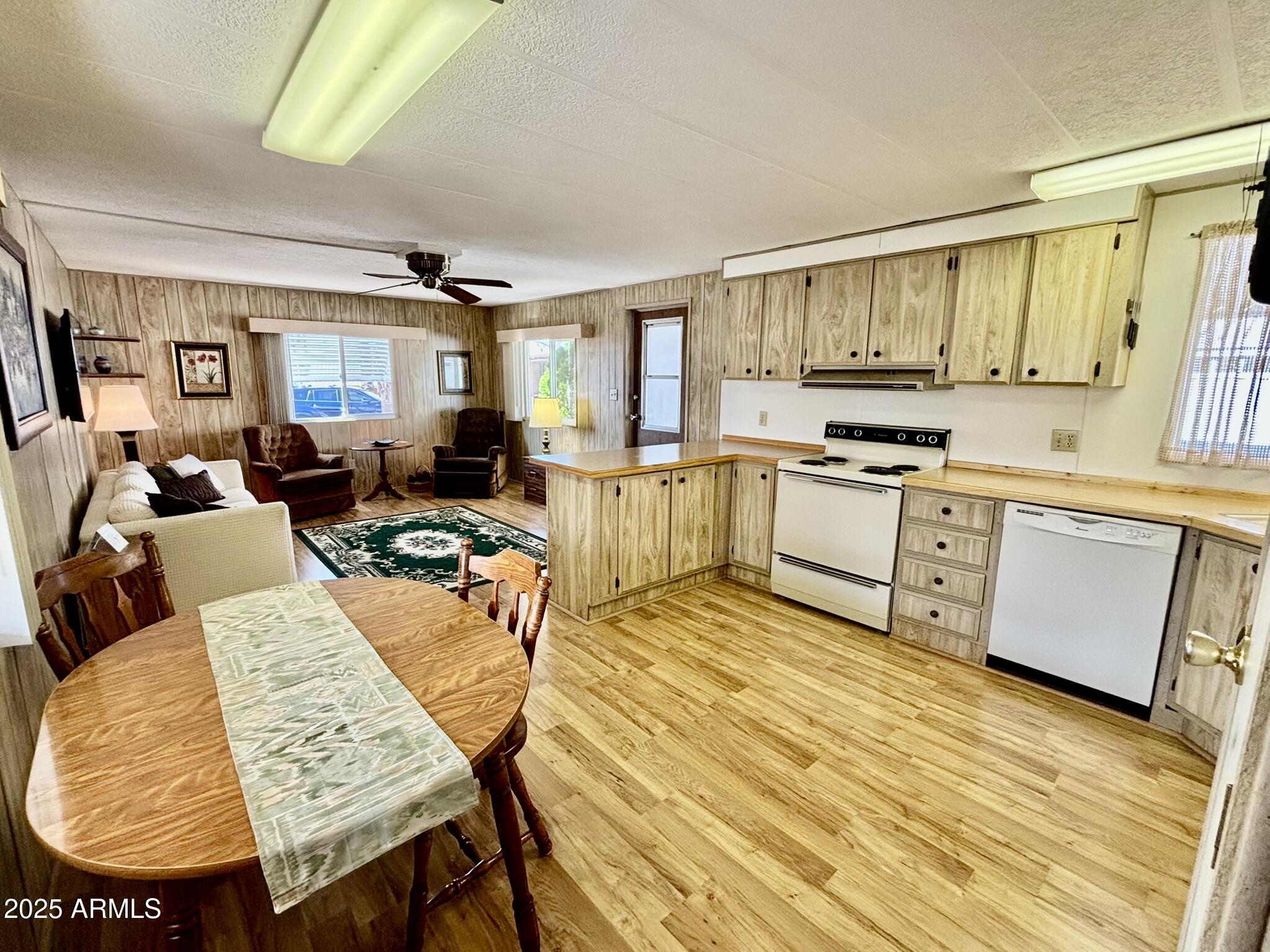 1050 East Broadway Avenue, Unit 44 Apache Junction, AZ 85119 - Photo 11 of 40 a view of a dining room with furniture window and wooden floor