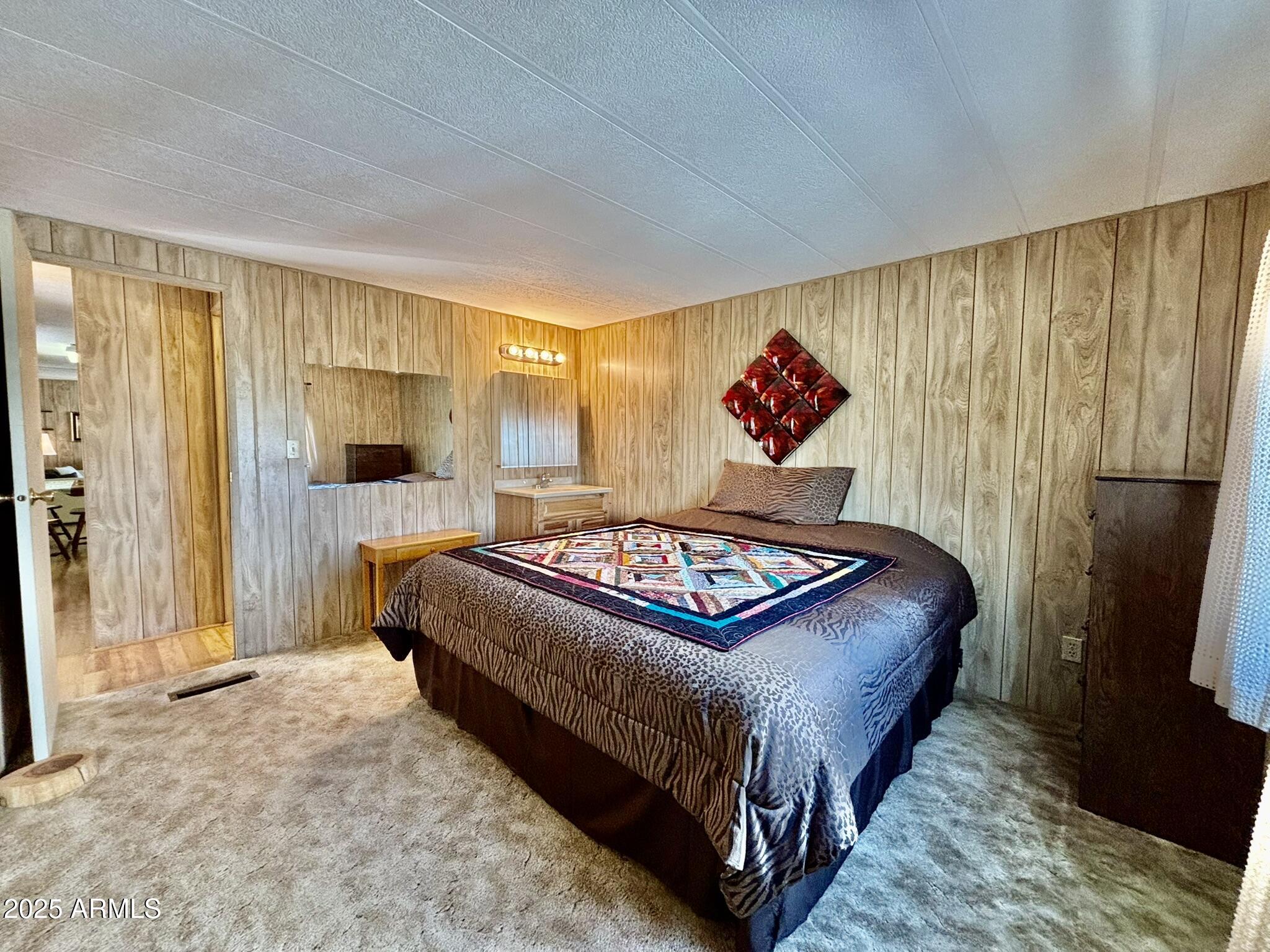 1050 East Broadway Avenue, Unit 44 Apache Junction, AZ 85119 - Photo 12 of 40 a bedroom with a bed and a flat screen television