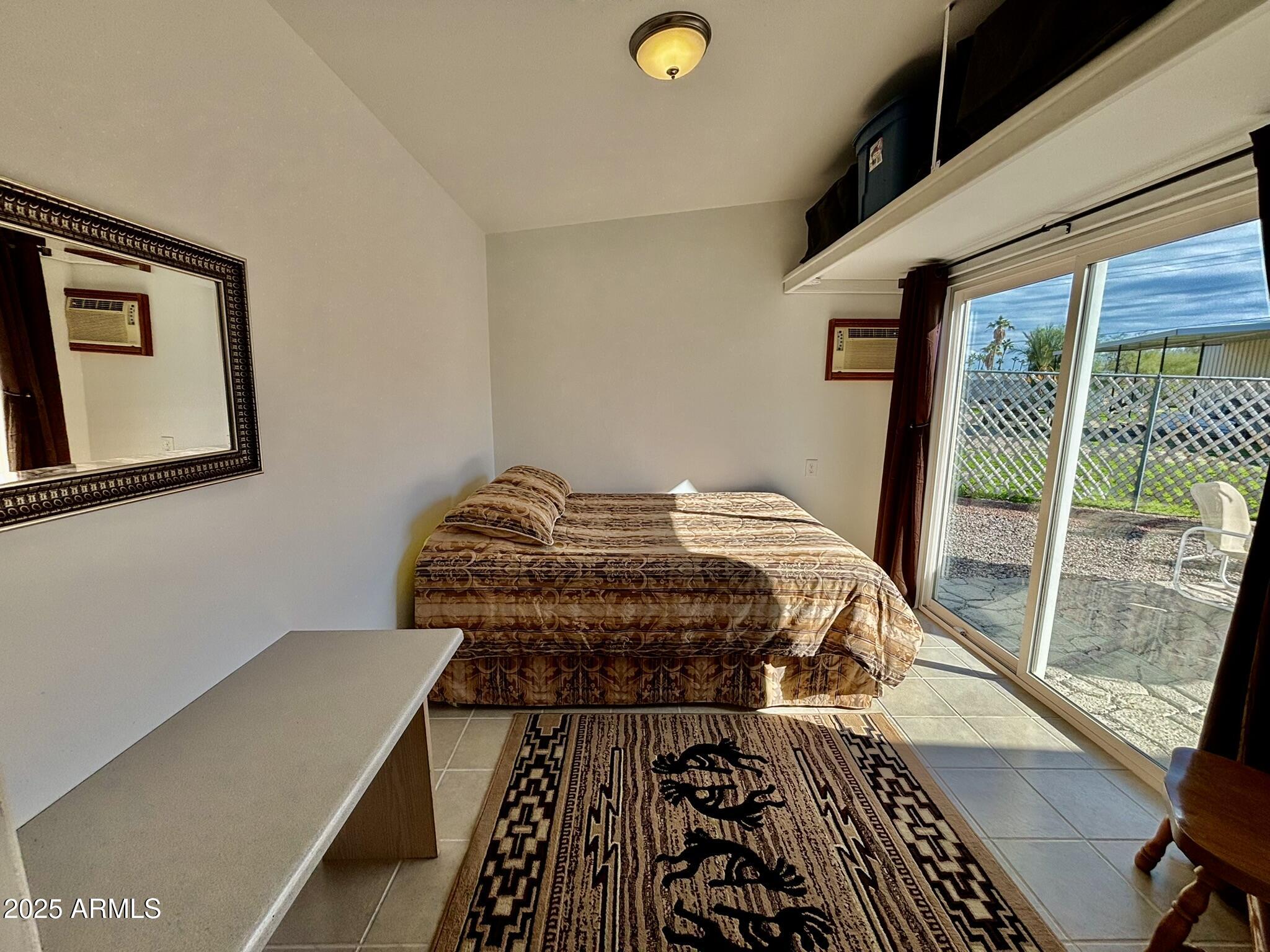 1050 East Broadway Avenue, Unit 44 Apache Junction, AZ 85119 - Photo 18 of 40 a bed sitting in a bedroom next to a window