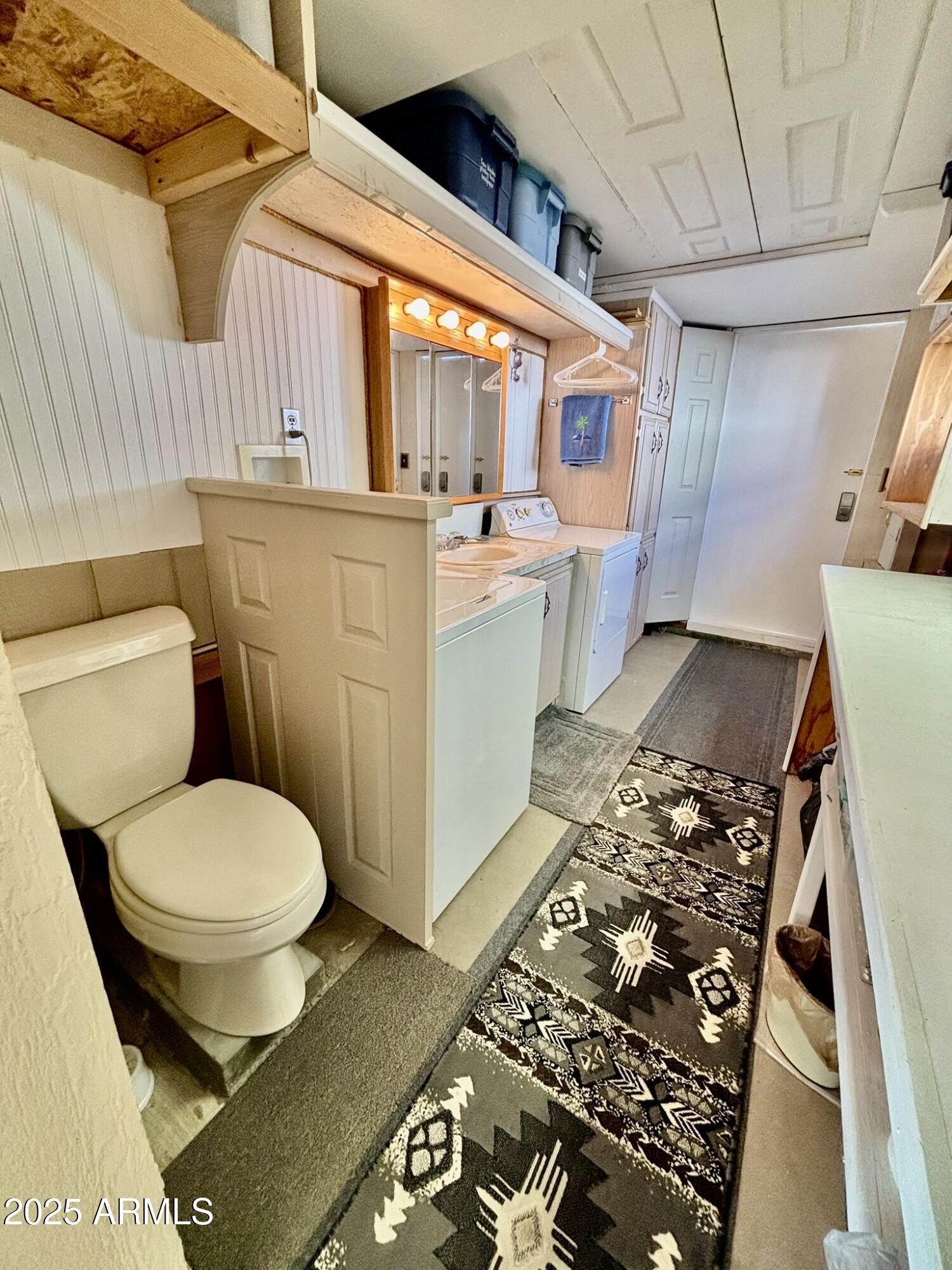 1050 East Broadway Avenue, Unit 44 Apache Junction, AZ 85119 - Photo 20 of 40 a bathroom with a toilet sink and mirror