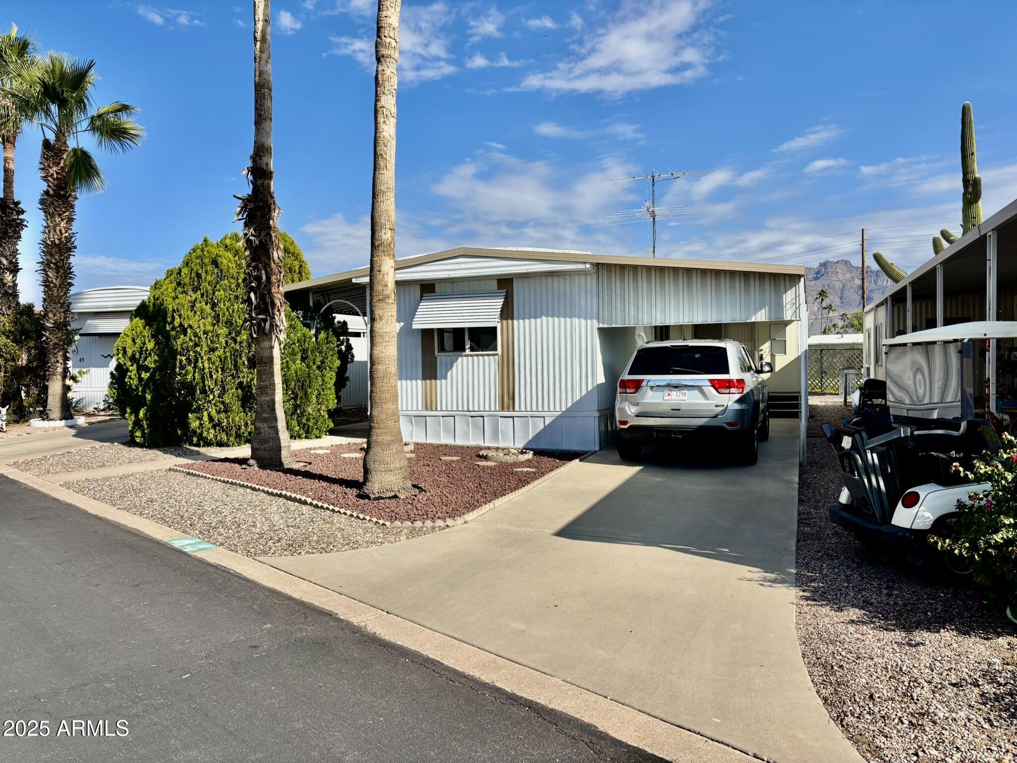 1050 East Broadway Avenue, Unit 44 Apache Junction, AZ 85119 - Photo 2 of 40 a car parked in front of a building