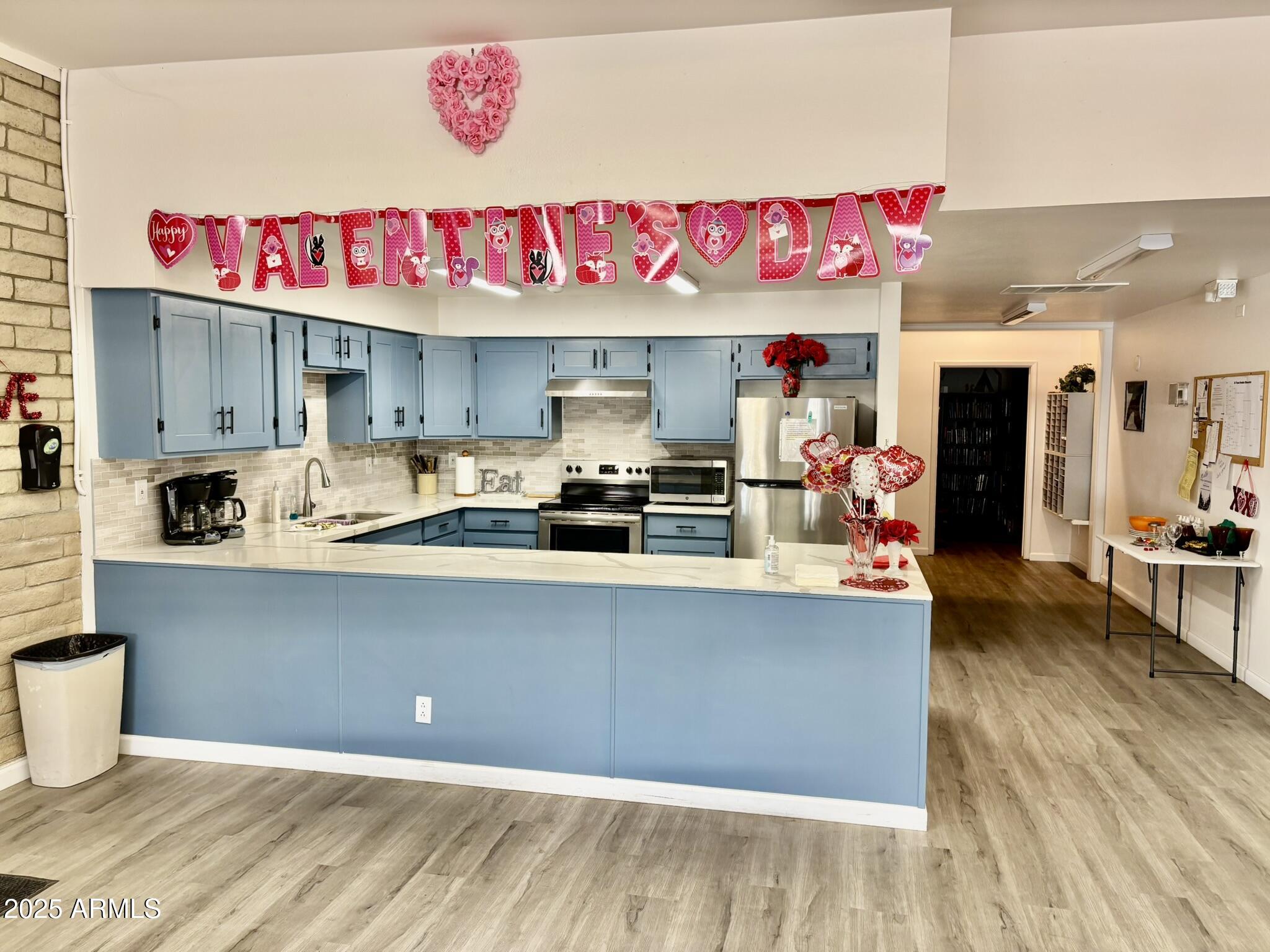 1050 East Broadway Avenue, Unit 44 Apache Junction, AZ 85119 - Photo 34 of 40 a kitchen with stainless steel appliances granite countertop a sink dishwasher and a microwave with wooden floor