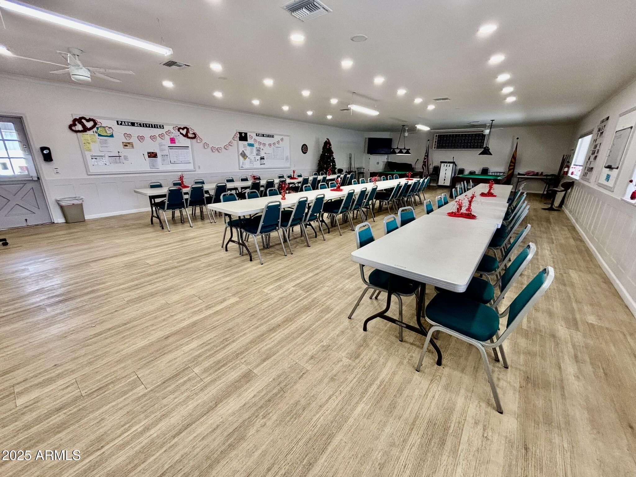 1050 East Broadway Avenue, Unit 44 Apache Junction, AZ 85119 - Photo 37 of 40 a room with lots of furniture and wooden floors