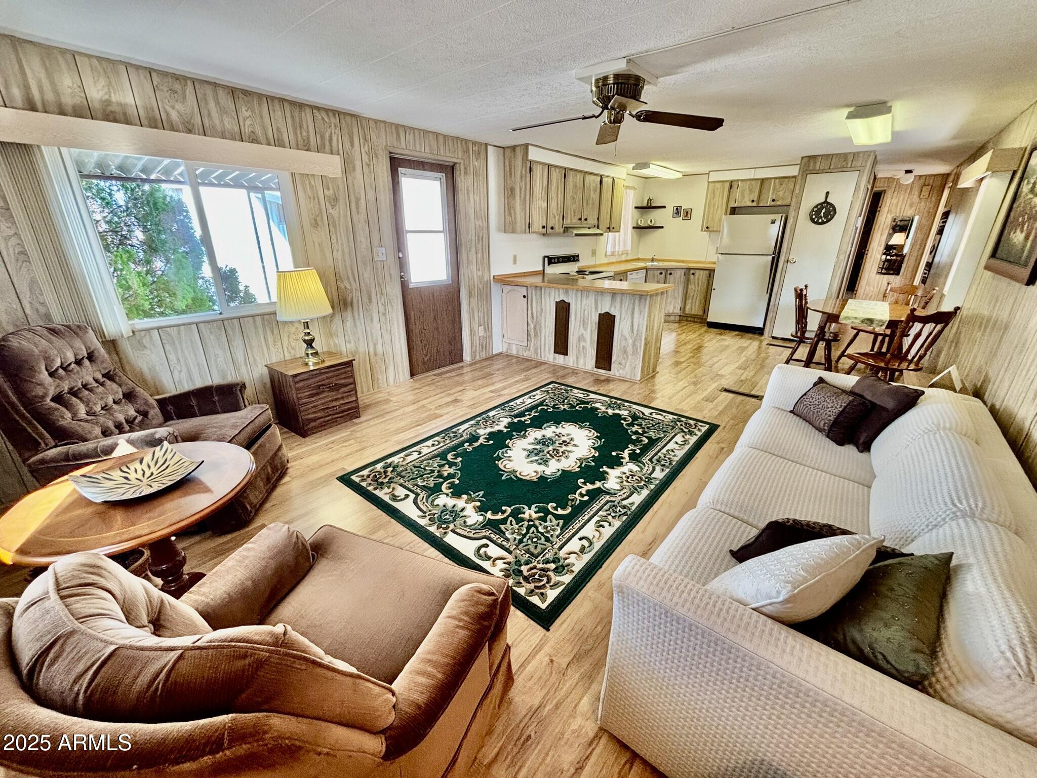 1050 East Broadway Avenue, Unit 44 Apache Junction, AZ 85119 - Photo 6 of 40 a living room with furniture and a flat screen tv