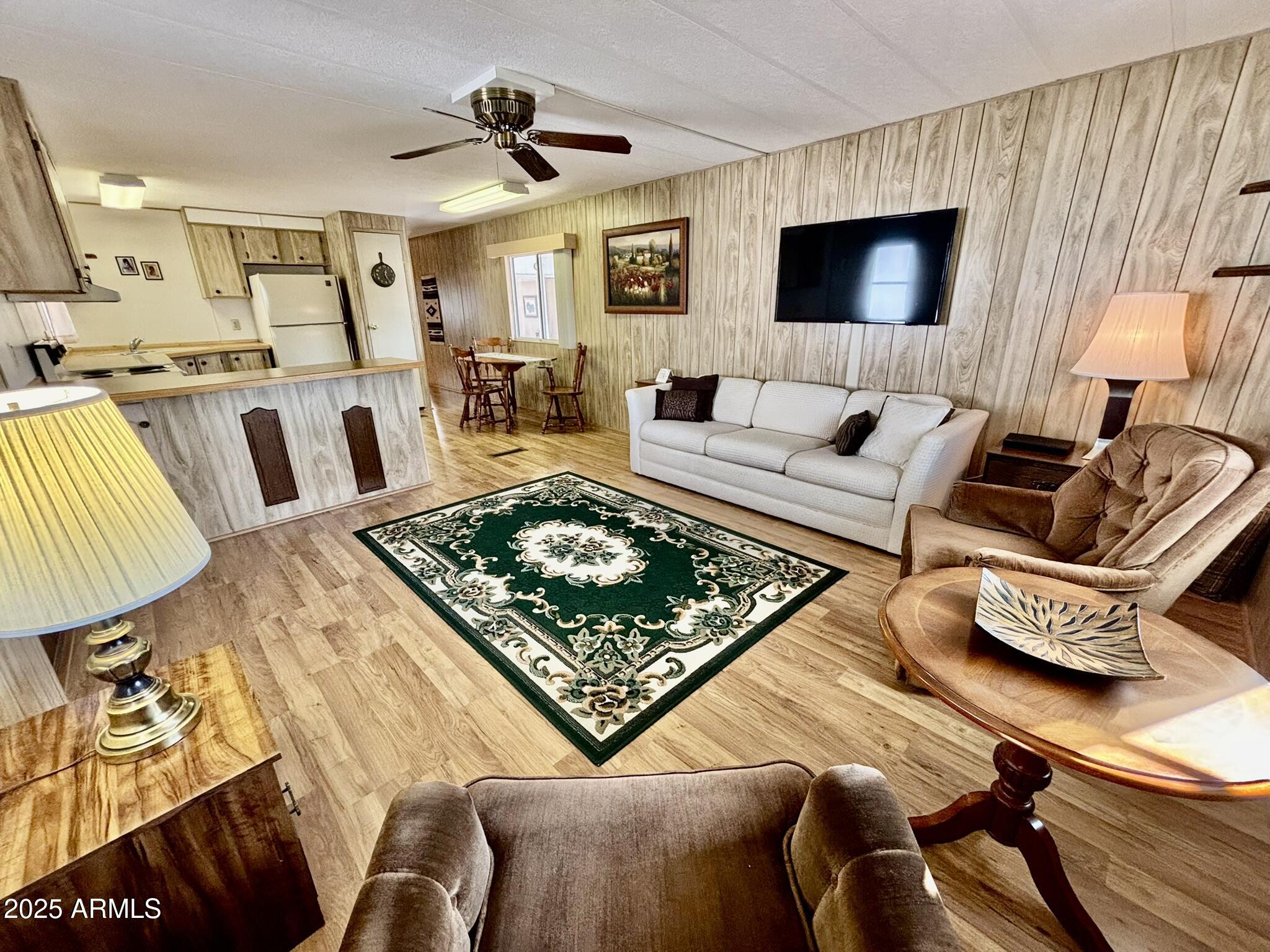 1050 East Broadway Avenue, Unit 44 Apache Junction, AZ 85119 - Photo 7 of 40 a living room with furniture and a flat screen tv