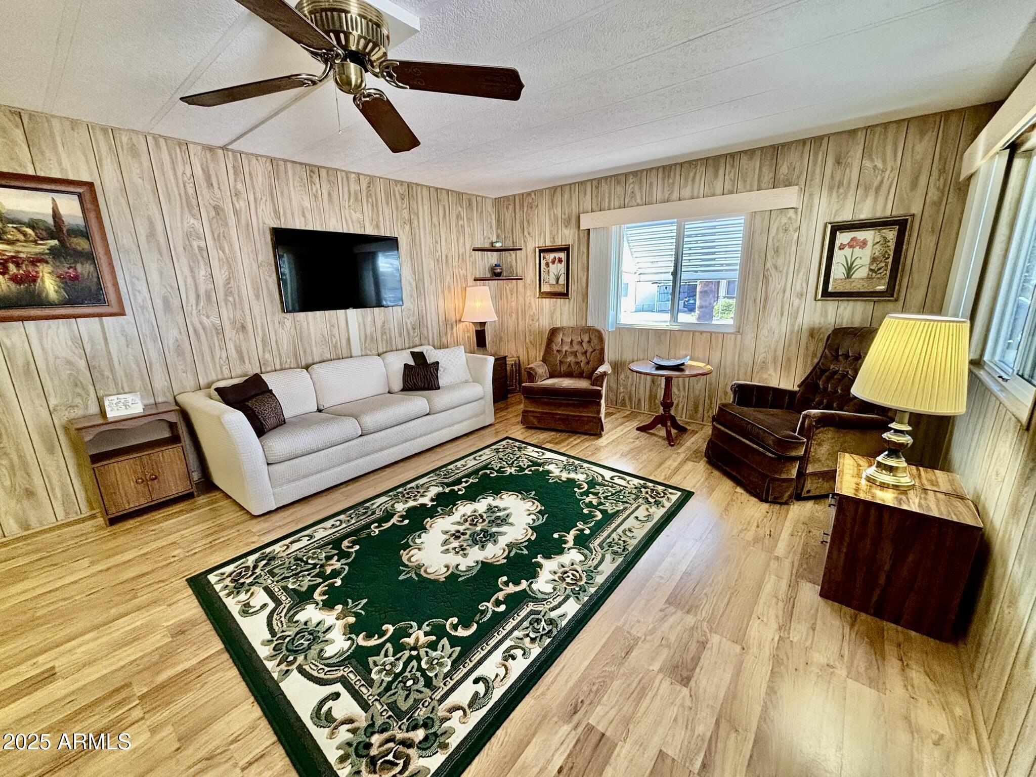 1050 East Broadway Avenue, Unit 44 Apache Junction, AZ 85119 - Photo 8 of 40 a living room with furniture and a flat screen tv