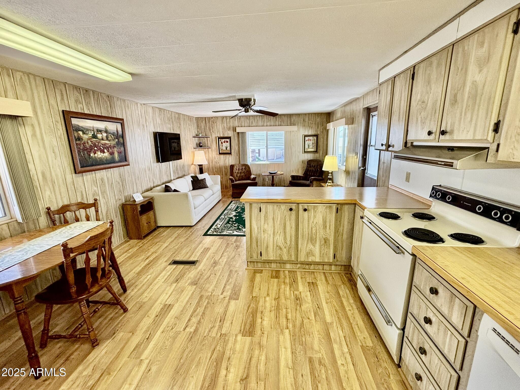 1050 East Broadway Avenue, Unit 44 Apache Junction, AZ 85119 - Photo 10 of 40 a living room with stainless steel appliances furniture stove top oven and kitchen view