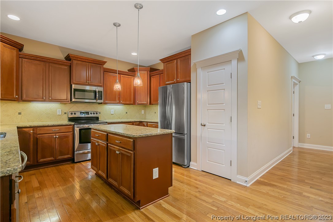 32 Shellnut Circle Spring Lake, NC 28390 - Photo 17 of 50 a kitchen with stainless steel appliances granite countertop a refrigerator stove microwave and sink