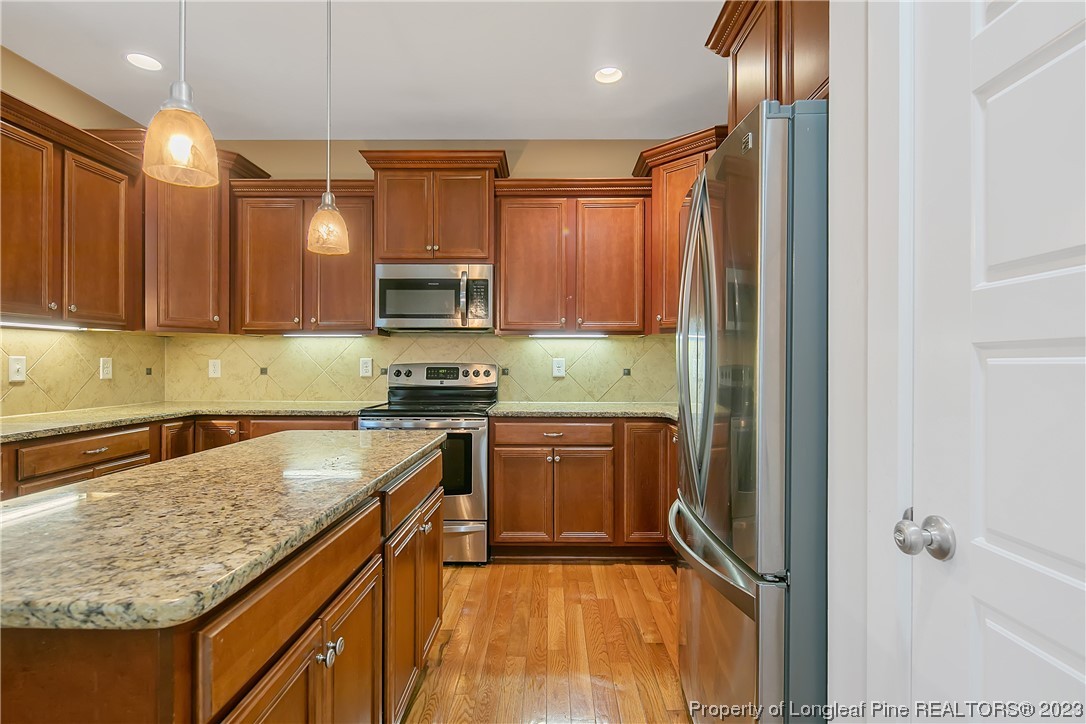 32 Shellnut Circle Spring Lake, NC 28390 - Photo 21 of 50 a kitchen with a granite countertop sink stove and cabinets