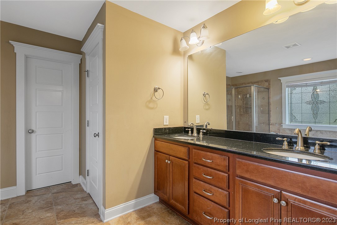 32 Shellnut Circle Spring Lake, NC 28390 - Photo 35 of 50 a spacious bathroom with a granite countertop sink mirror and double