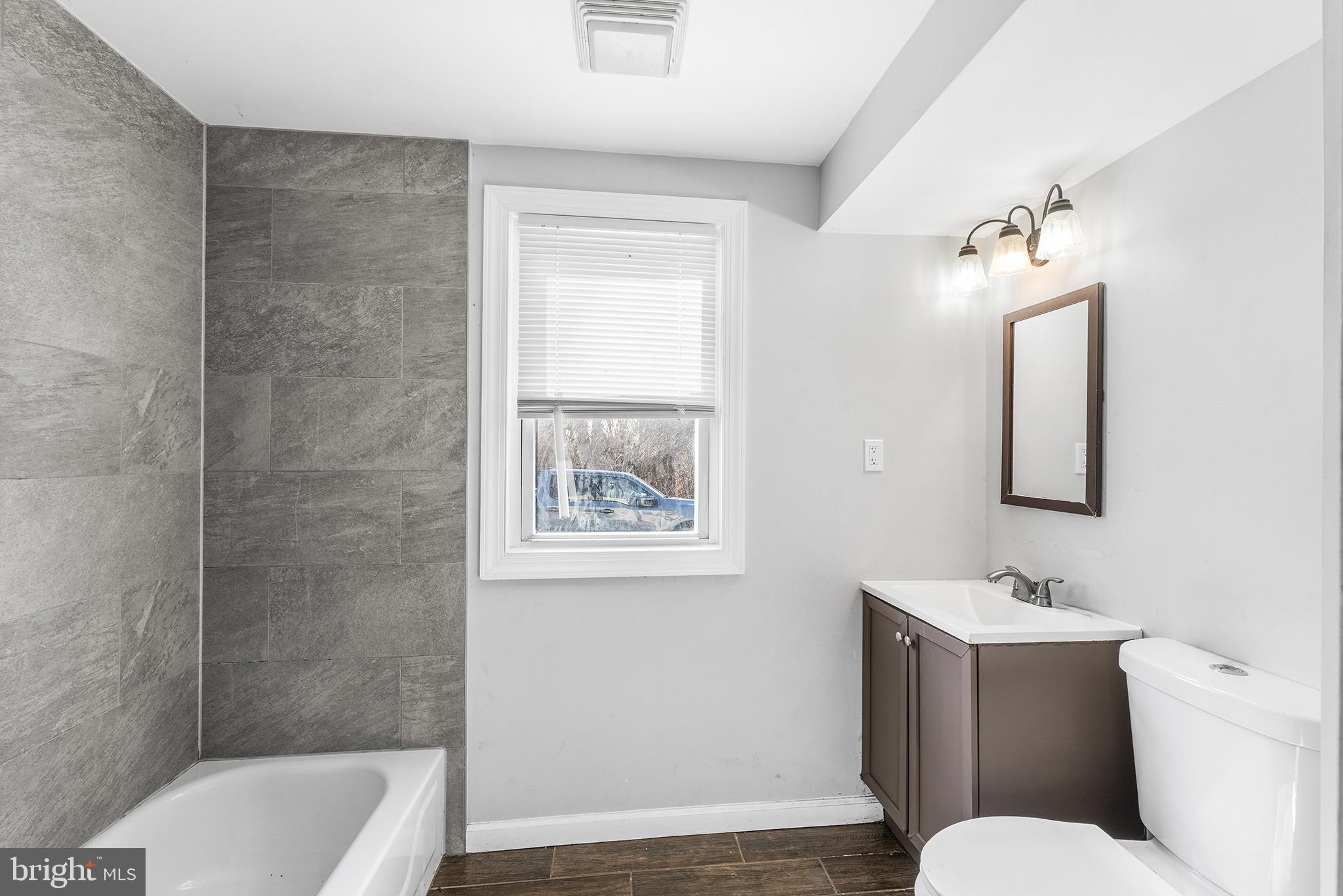 2 Fusting Avenue Baltimore, MD 21228 - Photo 11 of 26 a bathroom with a toilet a sink and mirror